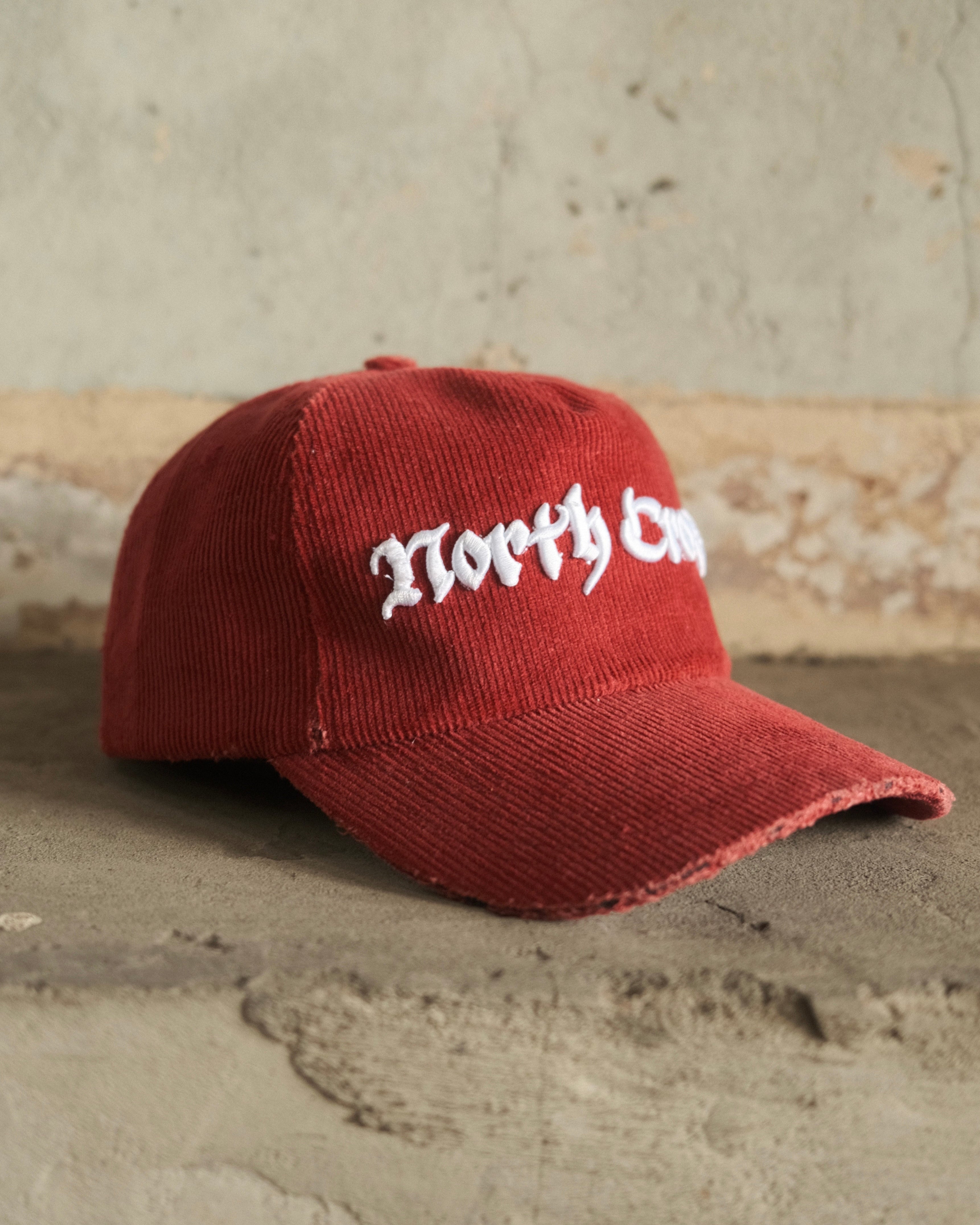 Red cord cap with North Cross embroidered on front