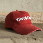 Red cord cap with North Cross embroidered on front