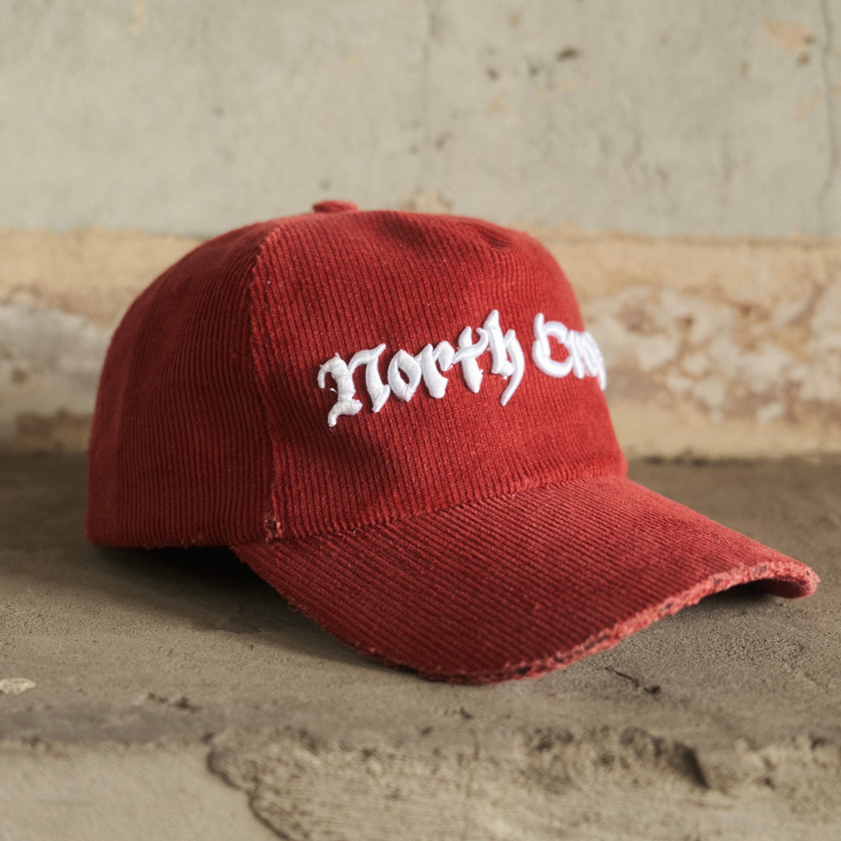 Red cord cap with North Cross embroidered on front
