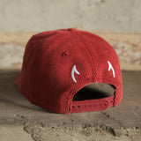Red cord cap with embroidered horns on back