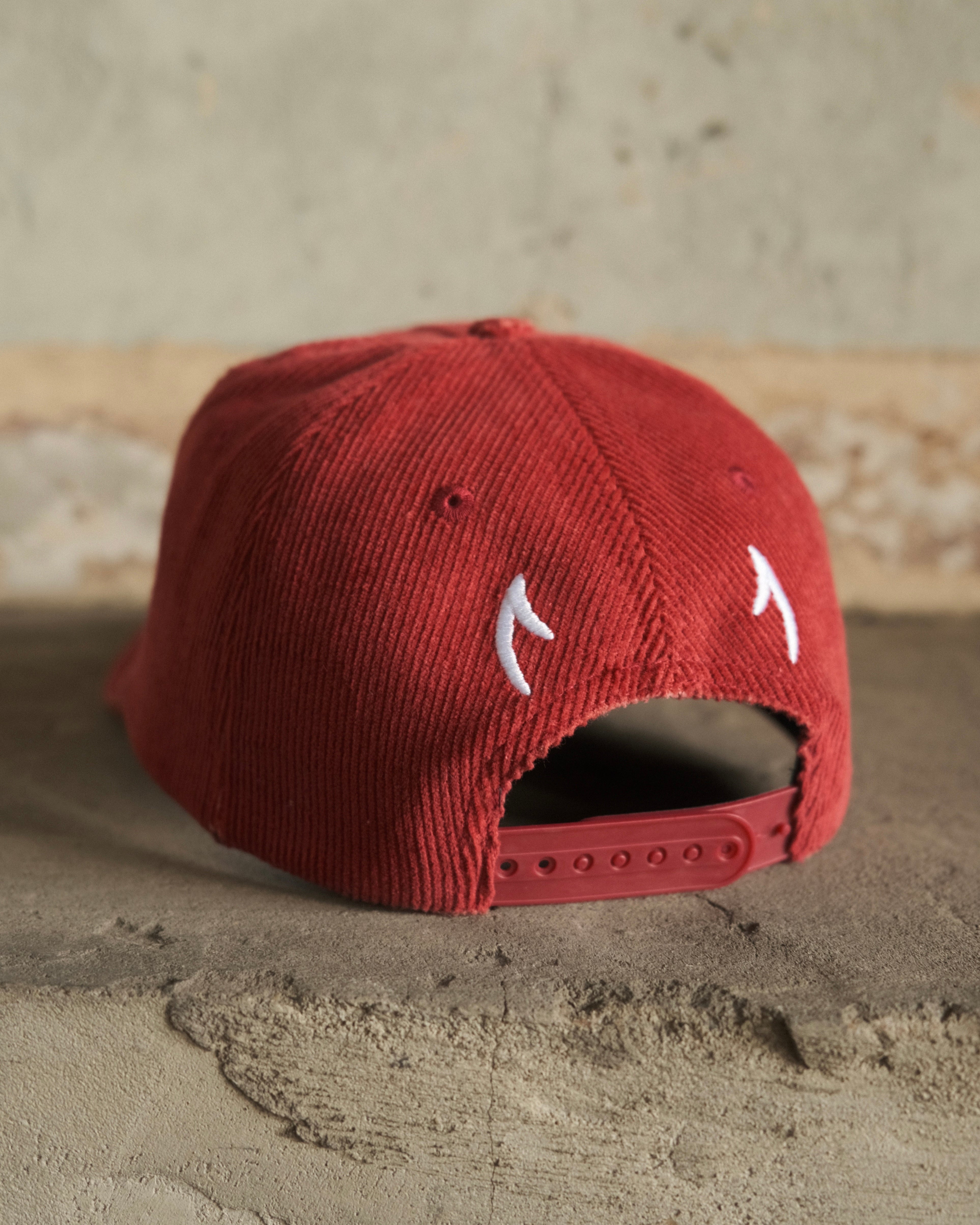 Red cord cap with embroidered horns on back